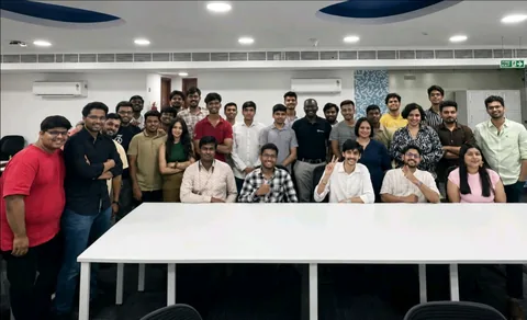 Group of participants gathered around classroom tables at an event