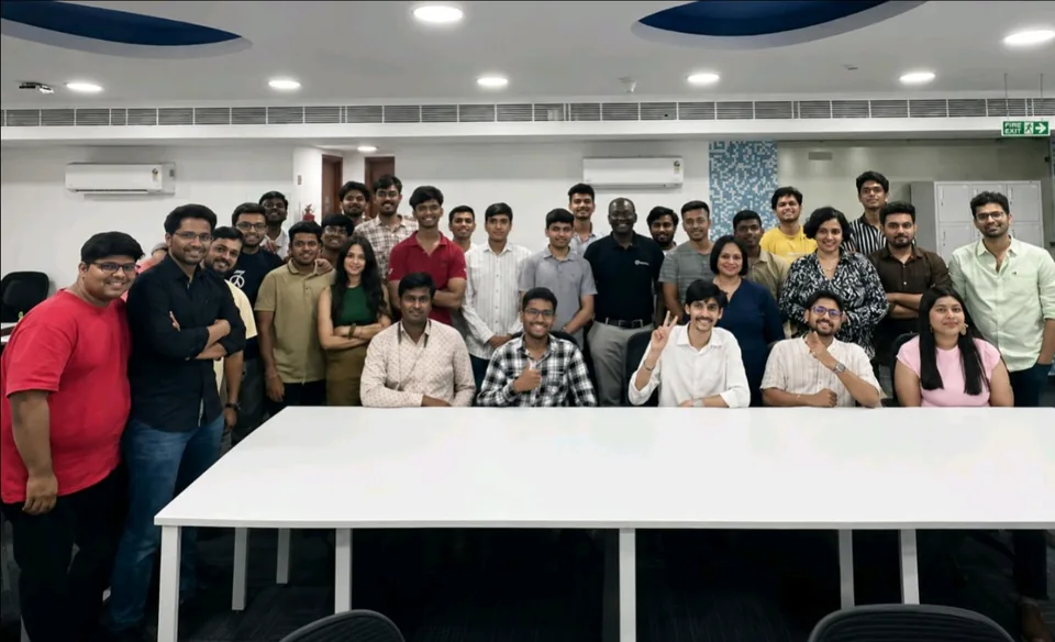 Shubham Sahu with participants gathered around classroom tables at an event