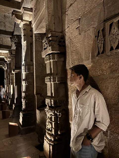 A personal photograph among carved stone columns.